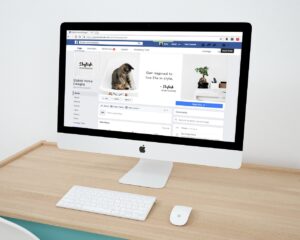 iMac displaying a Facebook page with social media design elements