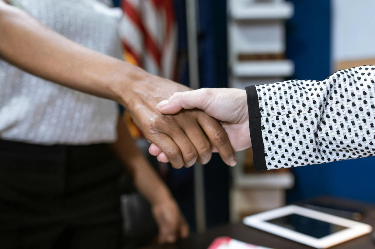 Homeowner shaking hands with contractor, establishing trust