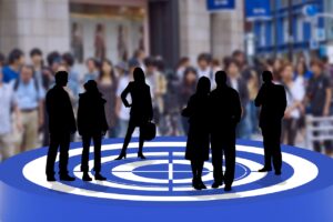 Target board with arrow hitting bullseye representing goals