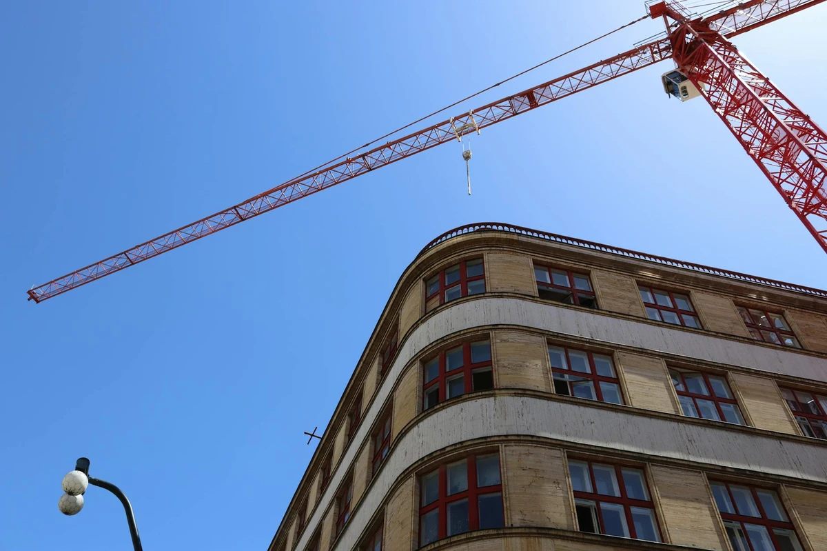 Low angle view of construction crane against blue sky
